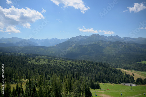 Fototapeta Naklejka Na Ścianę i Meble -  High Tatras and Male Ciche ski resort seen from a metal observation tower with a modern glass terrace offering a stunning panorama at Poronin, Poland. Majestic mountains peaks of High Tatra moutnains.