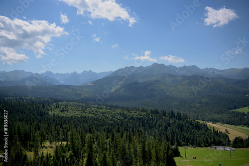 Fototapeta Naklejka Na Ścianę i Meble -  High Tatras and Male Ciche ski resort seen from a metal observation tower with a modern glass terrace offering a stunning panorama at Poronin, Poland. Majestic mountains peaks of High Tatra moutnains.