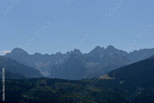 Fototapeta Naklejka Na Ścianę i Meble -  High Tatras seen from a metal observation tower with a modern glass terrace offering a stunning panorama at Poronin, Poland. Majestic mountains peaks of High Tatra moutnains.