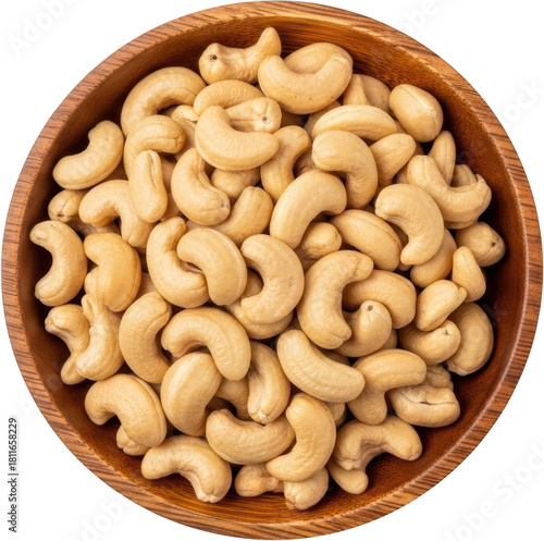 A top down view of a wooden bowl filled with a plentiful supply of whole raw cashew nuts showcasing their characteristic curved shape and creamy color