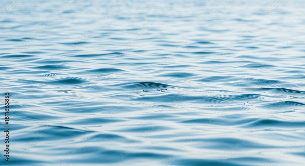Naklejka premium Calm blue ocean water reflecting the sunlight creating a serene natural ripple background scene