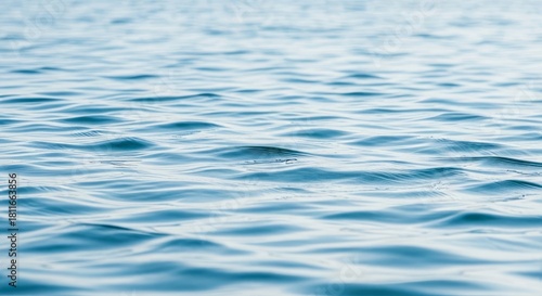 Fototapeta Naklejka Na Ścianę i Meble -  Calm blue ocean water reflecting the sunlight creating a serene natural ripple background scene