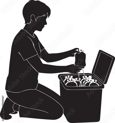 Silhouette of a child kneeling by a bin sorting waste and recycling items