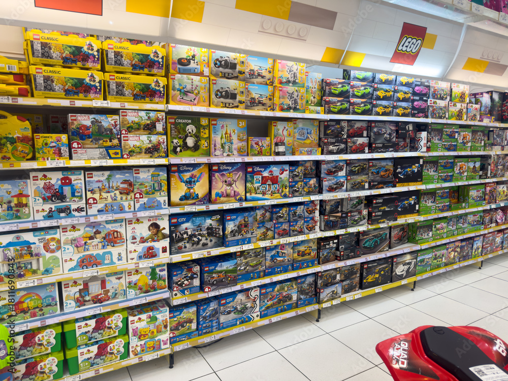Fototapeta premium BELO HORIZONTE, MG, BRAZIL – NOVEMBER, 17, 2025: Aisle of a toy store with shelves stocked full of various Lego sets.