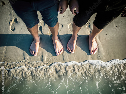 Wallpaper Mural Two Pairs of Feet on Beach Sand at Water's Edge Torontodigital.ca