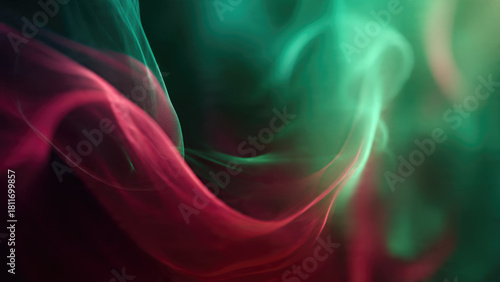 Dynamic abstract art featuring flowing crimson and emerald smoke trails swirling gracefully against a dark background, creating a vibrant, ethereal display.