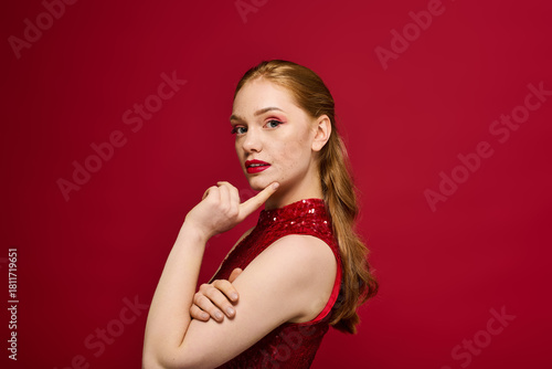 Capturing beauty and elegance of a young woman in a striking red outfit against a bold backdrop