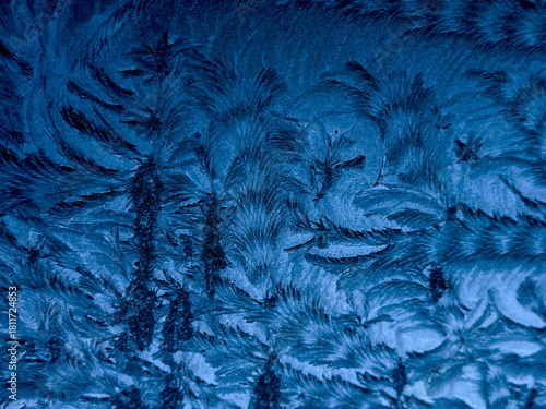 Silly Cold. Frozen patterns on glass. Dark blues