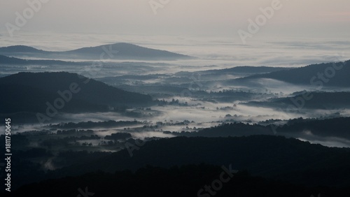 A smoky cloud inversion waits for dawn in Shenandoah National Park. Fog as thick as smoke fills the cold Virginia valleys in this moody pre-dawn landscape. 