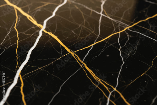 Abstract close up of dark marble with striking veins of white and gold creating a dynamic natural pattern