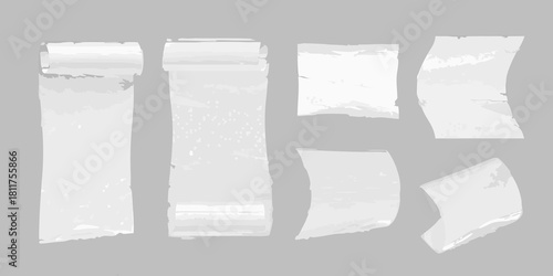 Torn and rolled paper scraps on gray background