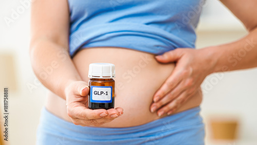 GLP-1 vial held by overweight person on stomach, weight loss, healthcare concept, medical treatment, diabetes management, metabolic health research, pharmaceutical marketing, clinical study imagery