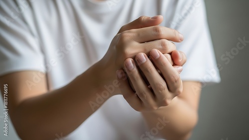 Person rubbing hands due to pain or discomfort