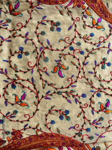 Fotografie Beautifully crafted Kashmiri crewel embroidery forms an intricate floral and vine pattern across the fabric