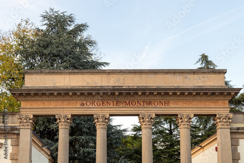 Close-up of the Sorgente Montirone neoclassical gateway at Parco Montirone in Abano Terme, Italy