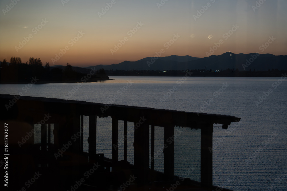 Obraz premium Sunset lake view from veranda with reflections.