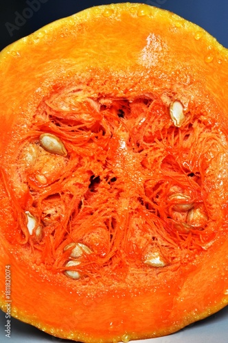 Close-up Juicy slice of pumpkin with bright orange flesh and seeds