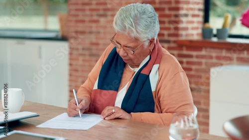 Writing, contract and senior woman in home for planning budget, pension fund and bills in morning. Documents, title deed and elderly person with filling paperwork for retirement application in house.