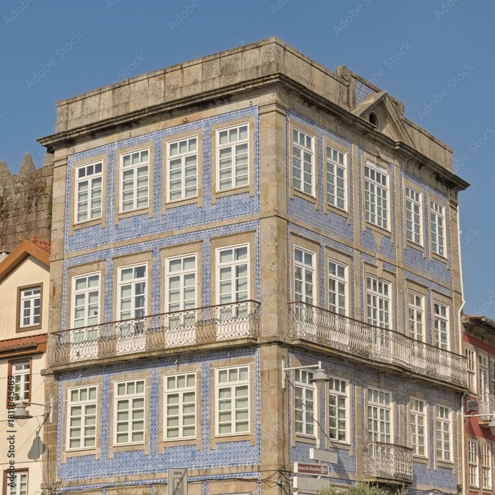 Fototapeta premium Neoclassical apartment building covered in blue azulejos tiles on a sunny day in Braga, Portugal 