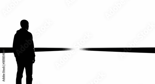 Silhouette of a solitary person looking towards a vanishing point.