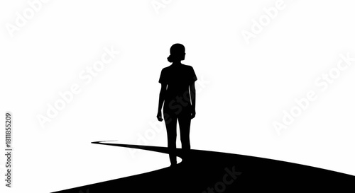 Silhouette of a person walking forward on a dark path.