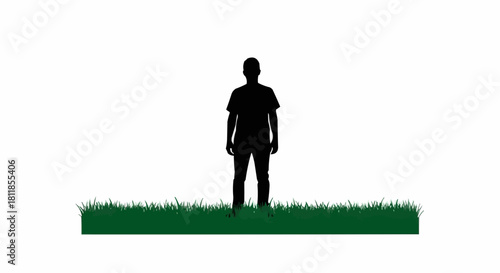 Silhouette of a man standing in a field of grass.