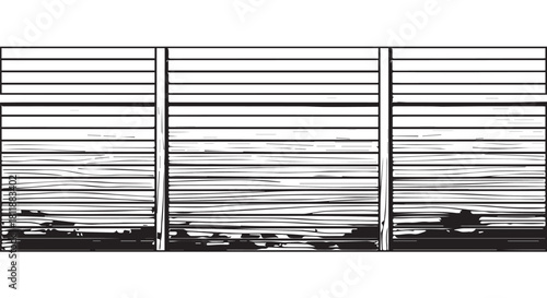 Long horizontal fence with shadows and stripes forming a stark monochrome urban pattern.
