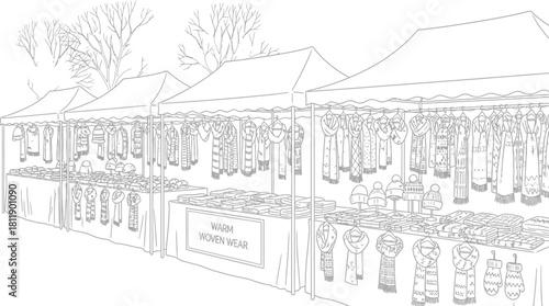 Outdoor market stall selling knitted scarves hats and gloves in black and white
