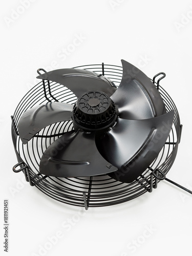 Black industrial metal fan on a white background. Ventilation equipment.