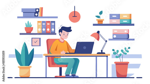 Young man working on laptop at a desk in a modern office