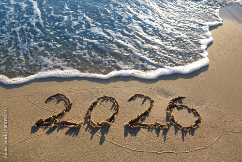 New Year 2026, lettering on the sunny beach sand.