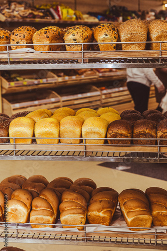 Freshly baked bread with raisins on a wooden stand in the bakery taken off the shelf in the supermarket.
