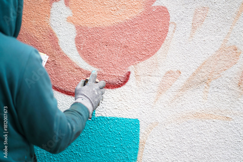 Painting graffiti on the wall. Close up. 