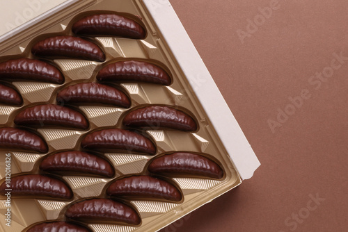 Принти на полотні Box of chocolate candies  on brown background. Top view