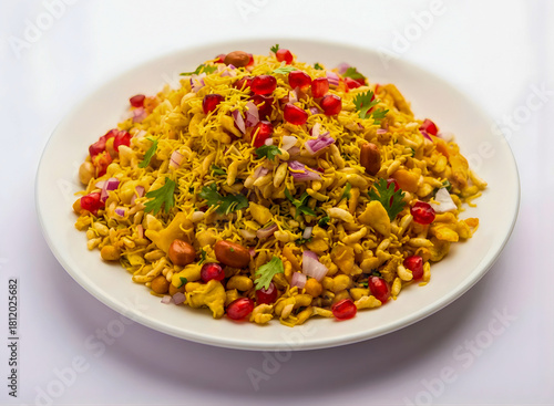 Indian Bhel Puri Chaat Street Food with Pomegranate and Sev on White Plate.