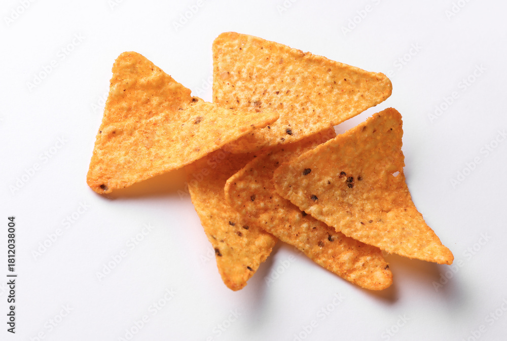 Fototapeta premium Triangular appetizing corn tortilla chips slices on white background