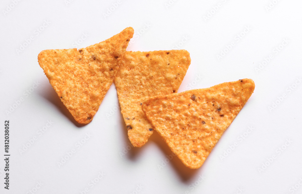 Fototapeta premium Triangular appetizing corn tortilla chips slices on white background