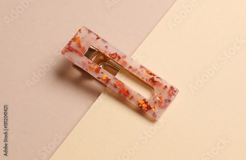 Stylish hairpins on beige background. Creative layout. Beauty concept