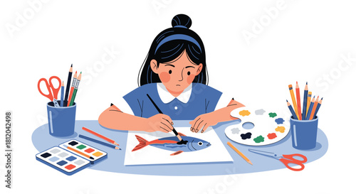 A young girl is focused on painting a fish with watercolors and a paintbrush on a table with art supplies.
