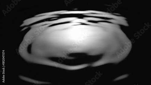 Water Drop Impact Creates Expanding Ripple Effect