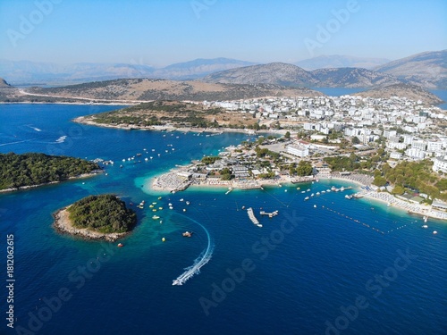 Ksamil, mass tourism vacation resort town in Southern Albania. Beach and coast drone view.