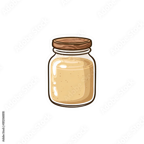 Jar of creamy spread with a wooden lid, isolated on a green background