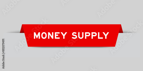 Red color inserted label with word money supply on gray background