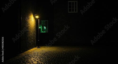 Street lamp illuminates a dark alleyway with brick walls and cobblestone pavement, creating a mysterious and slightly eerie atmosphere.