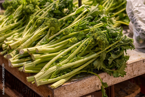 Cime di rapa, turnip greens, rapini or broccoli rabe in a street food market, green cruciferous vegetable, veggies, mediterranean cuisine, Puglia, Italy