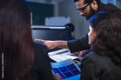 In a 24 7 Security Operations Center, a diverse incident response team works together under pressure, analyzing real-time threat intelligence data to defend against a live cyberattack.