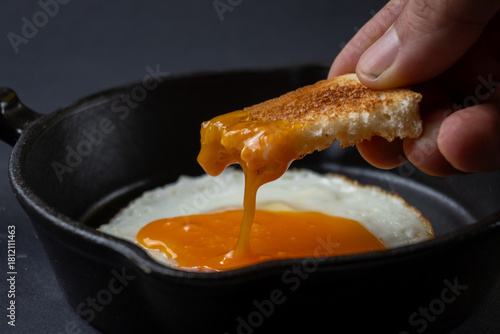 Toast Dipping Into Runny Egg Yolk