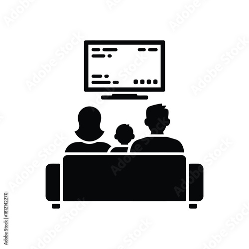 Family watching television together on a couch