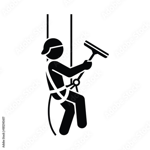 Window cleaner rappelling down a building with squeegee