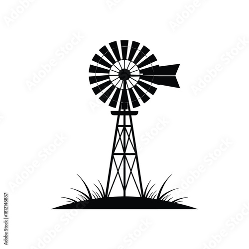 Classic farm windmill silhouette with grass